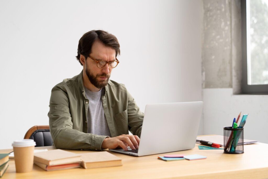 Man sitting at a computer typing.