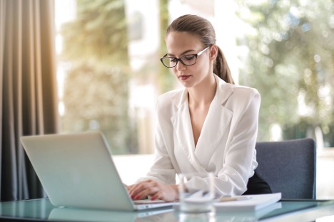 Woman in business clothing working at a laptop